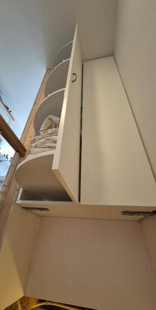 White floating cabinet above a staircase